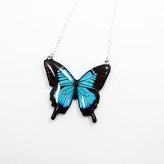 "❤️Introducing our Blue Butterfly Pendant, a handcrafted masterpiece inspired by the captivating Blue Emperor butterfly. Made with high-quality polymer clay and adorned with a mesmerizing resin art depiction of a blue butterfly, this pendant exudes elegance and charm.  The stainless steel chain adds a modern touch to its whimsical style. It's a unique and meaningful gift for anniversaries, symbolizing growth and enduring love. Embrace the beauty of nature with this exquisite Blue Butterfly Penda Blue Butterfly Necklace, Unique Butterfly, Necklace Resin, Polymer Clay Necklace, Clay Necklace, Whimsical Fashion, Butterfly Jewelry, Nature Inspired Jewelry, Statement Pendant