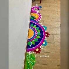 the floor is decorated with colorful designs on it's side and has a white wall behind it