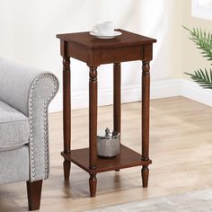 a small end table with a cup on it