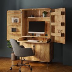 a desk with a computer on top of it and a chair in front of it