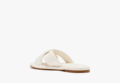 Find your paradise with our Rio slides. Made from faux leather these sandals take you from the pool to happy hour with ease… | Kate Spade Rio Slide Sandals, Cream - 8 Chic Synthetic Slippers For Vacation, Chic Synthetic Vacation Slippers, White Synthetic Sandals For Poolside, Chic Vacation Slides With Cushioned Footbed, Flat Summer Sandals For Pool, Kate Spade Sandals For Spring Vacation, Chic Slides With Cushioned Footbed For Vacation, White Open Toe Sandals For Pool, Chic Slide Slippers For Vacation