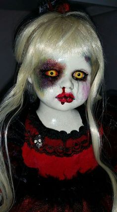 a creepy doll with white hair and red makeup on it's face is shown