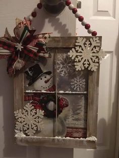 an old window decorated with snowflakes and decorations