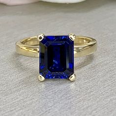 Emerald cut blue sapphire engagement ring yellow gold, Blue sapphire solitaire ring, September birthstone jewelry, Blue sapphire ring, #6132 #LabCreatedSapphire #PromiseRing #BirthdayGift #EmeraldCut #DiamondRing #WeddingRing #AnniversaryRing #BirthstoneRing #AnniversaryGift #EngagementRing Blue Sapphire Ring With Radiant Diamond Cut, Blue Sapphire Ring With Radiant Cut, Radiant Cut Sapphire Ring With Diamond Cut, Sapphire Ring With Radiant Diamond Cut, 14k Gold Diamond Cut Sapphire Promise Ring, Classic Royal Blue Sapphire Ring For Anniversary, Diamond Cut Sapphire Ring For Promise, Sapphire Ring With Diamond Cut For Promise, Diamond Cut Sapphire Promise Ring