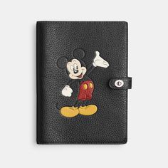 Beloved Disney characters meet iconic Coach design in this special collection starring the one-and-only Mickey Mouse and friends. Perfect for the doodlers ideators diarists note-takers and list-makers this distinctive notebook keeps you on point. Secured with our iconic turnlock closure the regenerative leather style features Mickey striking a pose. Crafted to last the leather is sourced from farms that use regenerative agricultural practices – those that help maintain and rejuvenate grasslands increase biological diversity soil health and productivity and could lead to increased carbon absorption. | Disney X Coach Notebook In Regenerative Leather With Mickey Mouse - Women's - Silver/black Coach Notebook, Biological Diversity, Coach Disney, Backpack Charm, Soil Health, Mickey Mouse And Friends, Leather Style, Strike A Pose, New Handbags