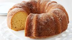 a bundt cake on a plate with one slice cut out