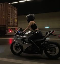 a woman riding on the back of a motorcycle