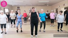 a group of older women are dancing in a dance studio with one woman holding her leg up