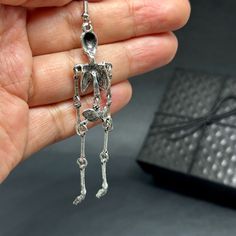 Get ready to dance the night away with these one-sided skeleton earrings in a vintage metallic silver finish! Perfect for any occasion - Halloween, Day of the Dead, a birthday party, or a night out with friends. Lightweight, articulated (all limbs are movable) and beautifully detailed, these earrings make a unique and original gift for yourself or someone special. Add some gothic, punk, and tattoo fashion to your look with these playful and quirky CALACAMANIA™ accessories Earrings details: Size: Silver Metal Jewelry For Costume Party, Spooky Silver Pierced Earrings, Silver Punk Earrings For Halloween, Metal Skull Single Earring, Silver Punk Earrings As A Gift, Spooky Silver Nickel-free Earrings, Bone Colored Metal Earrings For Pierced Ears, Spooky Nickel-free Silver Earrings, Spooky Nickel-free Jewelry For Party