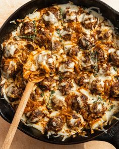 a skillet filled with meatballs and cheese