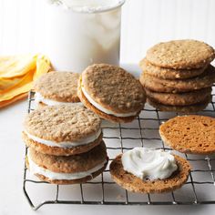 cookies and cream on a cooling rack next to a glass of milk