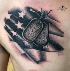 a chest tattoo with an american flag and two tags