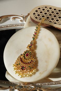 Enhance your traditional allure with the 'Jirisa - Gold AD Maang Tikka.' This exquisite piece, measuring approximately 5.51 inches in height and 1.77 inches in width, is available in two stunning options: Gold and Green, and Gold and Ruby-Green, each adding a touch of elegance to complement your style. The Gold and Green variant delicately features small teardrop-shaped stones dangling from the base, offering a subtle yet captivating charm to your appearance. Alternatively, the Gold and Ruby-Gre Ear Chain, Chandbali Earrings, Accessories Ear, Choker Necklace Set, Jhumka Earrings, Accessories Earrings, Artisan Craft, Bridal Sets, Chandelier Earrings