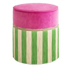 a pink and green stool sitting on top of a white floor