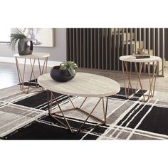 two tables sitting on top of a black and white rug