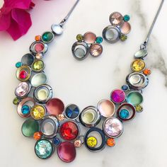 "Statement Necklace Set, Necklace Earring Set, Multicolor Necklace, Chunky Necklace, Necklaces For Women, Bold Colorful Necklace, Jewelry Set Our best selling statement necklace now comes with matching earrings. You asked and I listened. Featuring beautiful sparkling crystals and shimmery enamels this bib style necklace is sure to impress. This piece is so extraordinary you can expect many compliments when wearing this stunning necklace. The necklace and earrings are high quality, nickel free and plated in a gunmetal plating. The necklace is 18\" in length with a 2\" extension and the lightweight stud earrings are approximately 1\" in length." Eye-catching Multicolor Jewelry For Party, Multicolor Metal Jewelry For Party, Multicolor Metal Party Jewelry, Multicolor Metal Costume Jewelry, Multicolor Metal Jewelry Sets For Party, Multicolor Nickel-free Costume Jewelry, Multicolor Metal Costume Jewelry Sets, Multicolor Metal Jewelry Set For Gift, Multicolor Beaded Jewelry For Parties