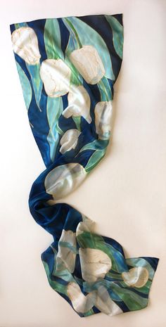 "Welcome to klaradar! https://www.etsy.com/uk/shop/klaradar?ref=seller-platform-mcnav Navy Tulips Silk Scarf/ Hand Painted Scarf/ Dark Blue Floral scarf painted. White Tulips painted on Deep Blue background. Unique handmade gift for women, Christmas gift mom. Silk Painting by Klaradar/ Christmas gift for mother-in-law. ►measurements- 17\"x71\" This Blue Tulips Scarf is painted on pure silk pongee 5. ►SHIP NEXT DAY See my luxury scarves and shawls here: https://www.etsy.com/shop/klaradar?ref=l2-s Hand Painted Blue Silk Scarf For Gift, Blue Floral Print Silk Scarf For Gift, Blue Floral Print Silk Scarf As Gift, Artistic Hand Painted Scarves For Gifts, Artistic Floral Print Scarf As A Gift, Artistic Floral Print Scarf As Gift, Artistic Floral Print Scarves As Gifts, Artistic Floral Print Scarves For Gifts, Artsy Blue Silk Scarf As Gift