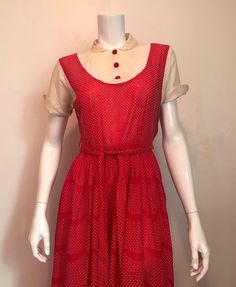 "1940's red and white dotted swiss pinafore dress. Fake pinafore front has a sheer white 'blouse' with Peter Pan collar and shaped turn back cuffed sleeves. Front of sleeve is white, back is dotted swiss. 3 red plastic buttons at center front. Dress has shirred waist, 2 belt loops and a 8 1/2' metal zipper at left side. Skirt fabric has a scalloped stripe of plain red every 3 1/4\". The hem is a selvedge edge, there is no turned up hem. Maker tag has been cut out. No size tag. Good condition. sleeve 6 1/2\" shoulder 5\" shoulder to shoulder 15\" chest 32\" waist 26\" shoulder to waist 13 1/2\" waist to hem 31\" hem 31\" laid flat, 62\" total length 44 1/2\" belt 1 1/4\"w x 63\"l" Retro Swiss Dot Dress For Spring, Red 1950s Spring Dresses, Retro Fitted Swiss Dot Dress, Fitted Retro Swiss Dot Dress, Retro Swiss Dot Dress, Fitted Vintage Dress With Peter Pan Collar For Summer, 1940s Outfits, Plain Red, Sheer White Blouse