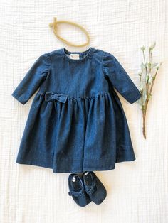 The Huxley Dress // Denim Dress // Baby Girl Dress // Dark Wash Denim Dress This adorable handmade dress is made with a beautiful dark washed denim. The back has three buttons and is easy to get on and off. To make sure you have the best fit, please check the weight and height of your child and compare to the sizes chart below. We would recommend sizing up if between sizes. The color may vary slightly due to differences in viewing devices. Fabric is pre-washed prior to making. Machine washable, Cute Denim Dress For Playdate, Indigo Cotton Dress With Buttons, Cute Cotton Denim Dress, Cute Cotton Denim Dress In Denim Blue, Cute Denim Blue Cotton Dress, Blue Denim Dress For Playdate, Blue Cotton Denim Dress For Playtime, Blue Cotton Denim Playtime Dress, Fitted Denim Blue Cute Denim Dress