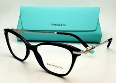 Tiffany & Co. EYEGLASSES  NEW AUTHENTIC WITH CUSTOM MADE READING GLASSES  Model: TF 2219-B Size : 54-16 Frame color: Black & Siver Description:  Classic Black Cat-Eye style plastic frames with Silver metal temples decorated with Swarovski Crystals and black & Tiffany blue plastic temple tips. It is customized with highest quality plastic reading-magnifying lenses of your choice. Please select from options listed above or contact us if you need these lenses customized to your prescription. (addit Tiffany Prescription Glasses Frames, Glasses Model, Magnifying Lens, Black Cat Eyes, Silver Frames, Tiffany Blue, Reading Glasses, Tiffany & Co., Classic Black