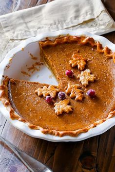 a slice of pumpkin pie with cranberries on top