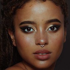 a close up of a woman's face with freckles on her nose