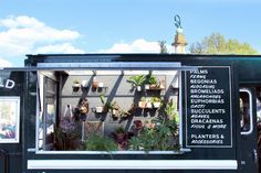 a food truck with plants on the side