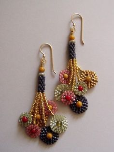 two pairs of beaded earrings on a white surface