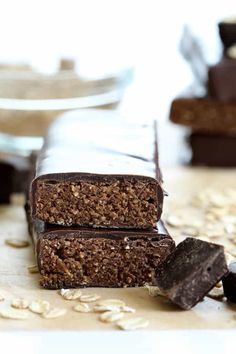 two pieces of chocolate and oatmeal bar on top of a wooden table