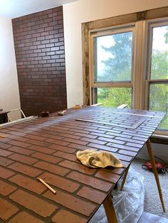 a room with a large brick table in the process of being built and installed by someone else