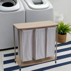 two laundry machines sitting next to each other on top of a blue and white rug