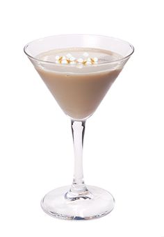 a martini glass filled with chocolate and marshmallows