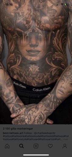 a man with tattoos on his chest and arms is standing in front of the camera