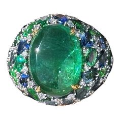 Discover the allure of the Remarkable Emerald Sapphire Diamond 18K Yellow Gold Ring, meticulously crafted from 18K yellow gold and adorned with dazzling diamonds (0.67 ct), radiant emeralds (22.56 ct), and vivid sapphires (5.47 ct). Symbolizing luck, protection, and growth, this opulent ring features a prominent 6.45 ct amethyst, flanked by exquisite cat's eye and tsavorite. Weighing 19 grams, this piece is a testament to luxury and meaning. 18k Yellow Gold Ring, Yellow Gold Ring, Gem Stone, Rings For Her, Sapphire Diamond, Birthstone Jewelry, Yellow Gold Rings, Cocktail Rings, Amazing Jewelry