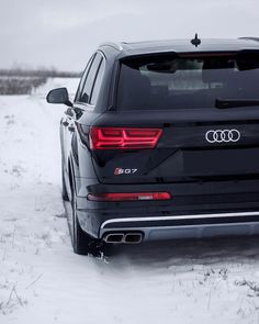 the rear end of an suv parked in snow