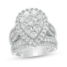 a white gold ring with two rows of diamonds on the band and a pear shaped center