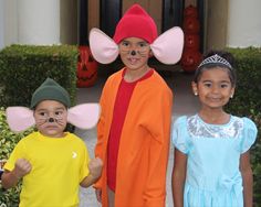 three children in costumes with ears and nose painted to look like mice, one wearing a mouse costume