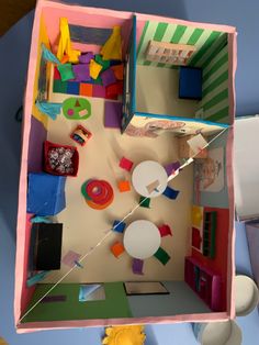 an overhead view of a toy house made out of construction paper and cutout shapes