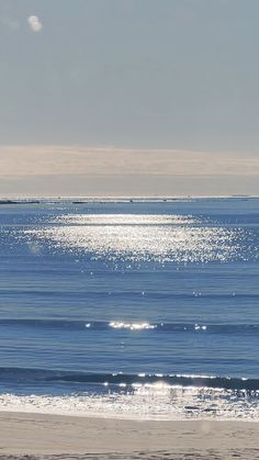 an ocean view with the sun reflecting on the water