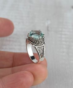 This 925 Sterling Silver Filigree Art Greek Key Meander Pattern Women's Cocktail Ring is a beautiful and unique piece of jewelry that is sure to become a treasured possession. It is made with high-quality materials and features a beautiful aquamarine gemstone that is sure to add a touch of elegance to any outfit. The ring is made of 925 sterling silver, which is a hypoallergenic metal that is resistant to tarnishing. The ring is also nickel-free, making it a good choice for people with nickel allergies. The ring is available in a variety of sizes, from 5 to 12.5, with half sizes. It also comes with a silver polish cloth, velvet pouch, and a luxurious gift box. The ring is a beautiful and unique piece of filigree art, which is a type of metalwork that uses fine threads of gold or silver to Handmade Silver Topaz Ring Fine Jewelry, Sterling Silver Topaz Ring With Intricate Design For Gift, March Birthstone Necklace, Soldered Jewelry, Soldering Jewelry, Pretty Pendant, Pattern Ring, Art Women, March Birthstone