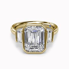 an emerald cut diamond ring with three side stones