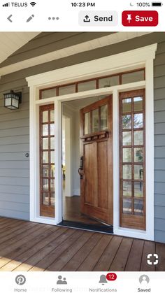 the front door is open and there are two doors on each side of the house