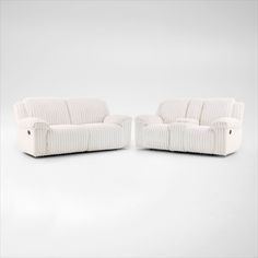 two white couches sitting next to each other on top of a white flooring