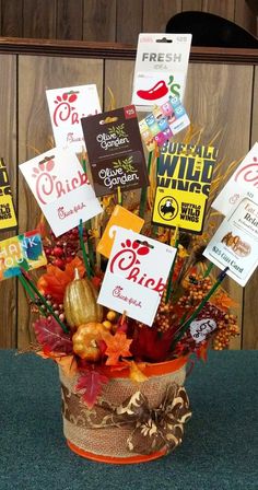 a bucket filled with lots of different signs and decorations on top of a table next to a wooden wall