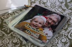 a couple of pictures on top of a table next to a wallpaper covered floor