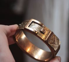 Beautiful mid Victorian gilt / gild filled bangle, shaped as a belt Shows signs of age, scuffed edges, chain is missing, belt design prong is missing.  Still it retains it's beauty and has beautiful etched designs, including a meander motif  Great for study of collection of design examples SOLD AS IS Full weight - 33.38 grams Width  - 1.8  cm Inner perimeter approx 15.5 cm  Note it is a real vintage item, not a brand new item.  It is a piece of history Please inspect photos well, they are part o Antique Bronze Bracelet For Wedding, Antique Gold Metal Bangle, Antique Bronze Bracelets For Formal Occasions, Antique Bronze Bangle Jewelry, Antique Jewelry With Decorative Band For Ceremonies, Antique Jewelry With Decorative Band For Ceremonial Use, Antique Ceremonial Jewelry With Decorative Band, Formal Gold Bracelets With Antique Finish, Formal Gold Bracelet With Antique Finish