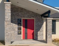 a red door is on the side of a building