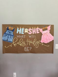 a bulletin board with clothes hanging from it's sides and the words, he or she what will lady hope be?