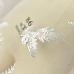 a close up view of the back of a hat with embroidered leaves on it,