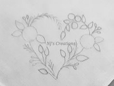 a heart - shaped embroidered onto a napkin with the words n's creations on it